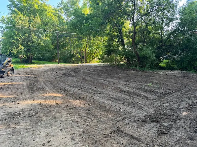 Recently graded dirt work site with equipment