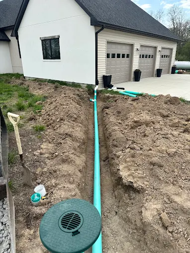 Drainage pipe installation beside a home