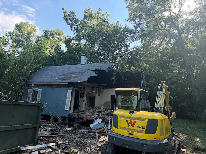 Excavator working during a house demolition